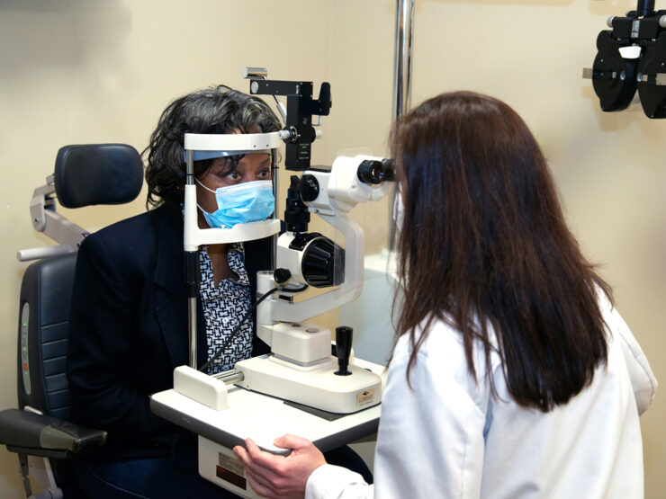 A doctor examines a patient's eyes.