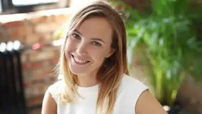 woman in white dress smiling at camera