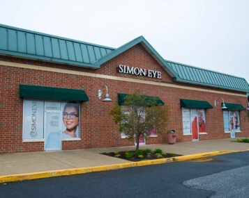 A brick building with Simon Eye in large green letters on the front store-face.