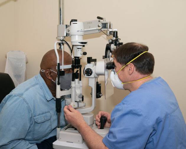A doctor examining a patient's eyes.