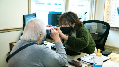 A doctor examining a patient's eyes.