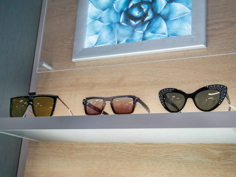 Three pairs of sunglasses on display next to one another.