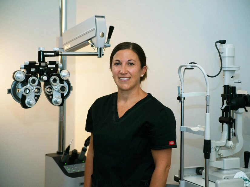 A doctor with eye exam equipment.