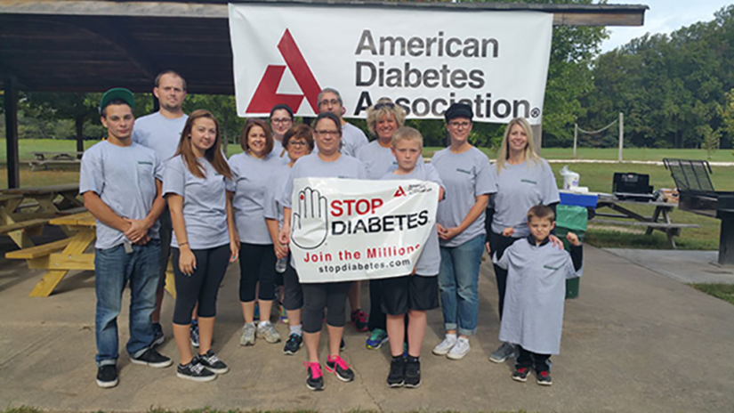 A group of people with a sign that reads, "Stop Diabetes".