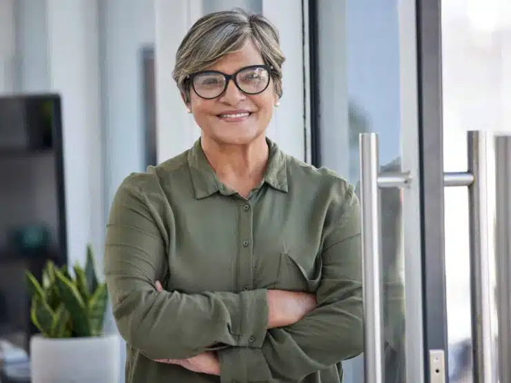 a woman smiling with eye glasses on