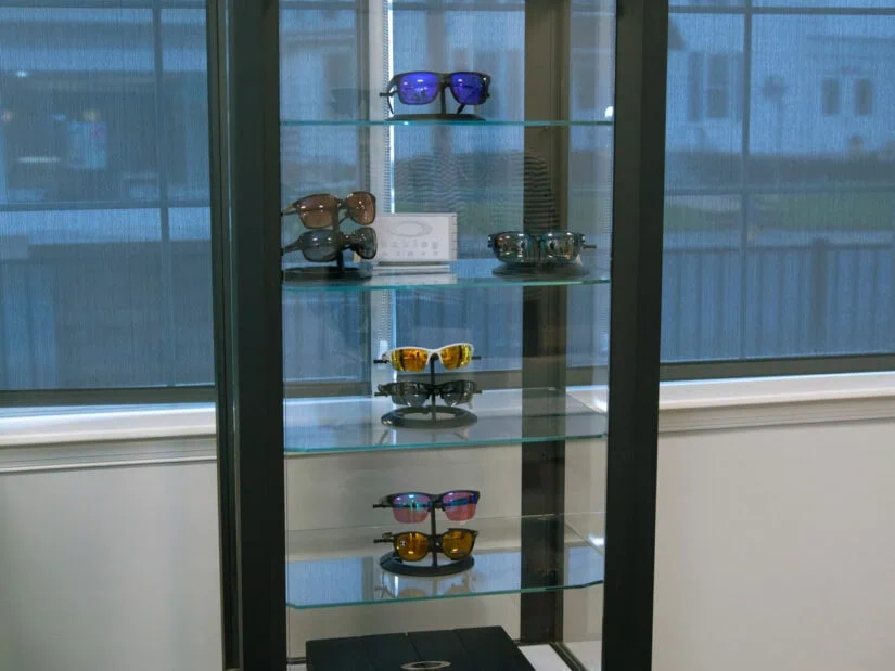 Eight pairs of sunglasses in a display case.