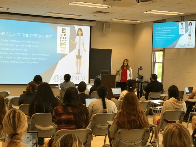 Woman sharing a presentation to a group of students.